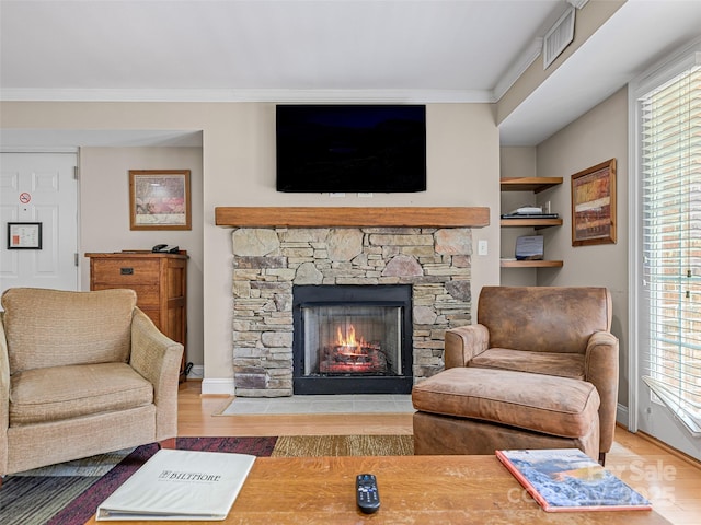 329 Bowling Park Rd, Asheville, NC 28803 - interior space with baseboards, a stone fireplace, ornamental molding, visible vents, and wood finished floors