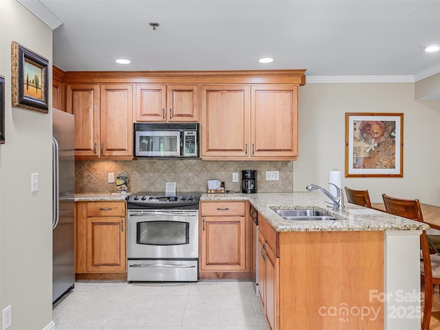 kitchen featuring ornamental molding, a sink, a peninsula, tasteful backsplash, and appliances with stainless steel finishes