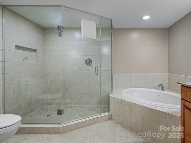 bathroom with recessed lighting, toilet, a bath, a shower stall, and tile patterned floors