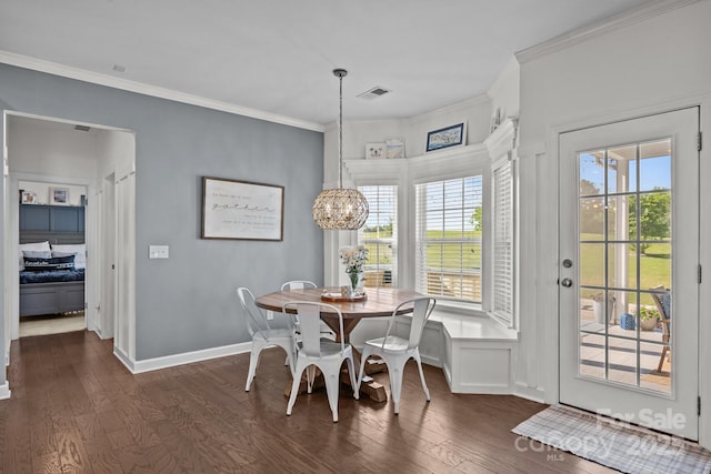9871 Travertine Trl, Davidson, NC 28036 - dining room with dark wood-style flooring, crown molding, a chandelier, and baseboards
