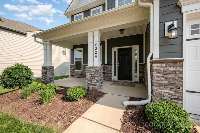 4324 Falls Lake Dr SW, Concord, NC 28025 - property entrance with a porch and stone siding