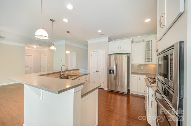 4324 Falls Lake Dr SW, Concord, NC 28025 - kitchen with appliances with stainless steel finishes, a sink, ornamental molding, dark wood finished floors, and a large island with sink