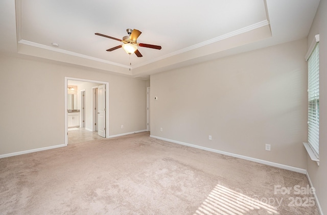 4324 Falls Lake Dr SW, Concord, NC 28025 - empty room featuring a tray ceiling, ceiling fan, crown molding, and light colored carpet