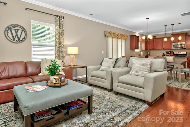 14837 Dungannon Ct, Charlotte, NC 28278 - living room featuring dark wood-style floors, ornamental molding, baseboards, and a chandelier
