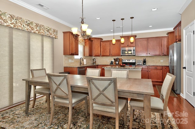 14837 Dungannon Ct, Charlotte, NC 28278 - kitchen featuring stainless steel appliances, a center island, a chandelier, dark wood-style flooring, and tasteful backsplash