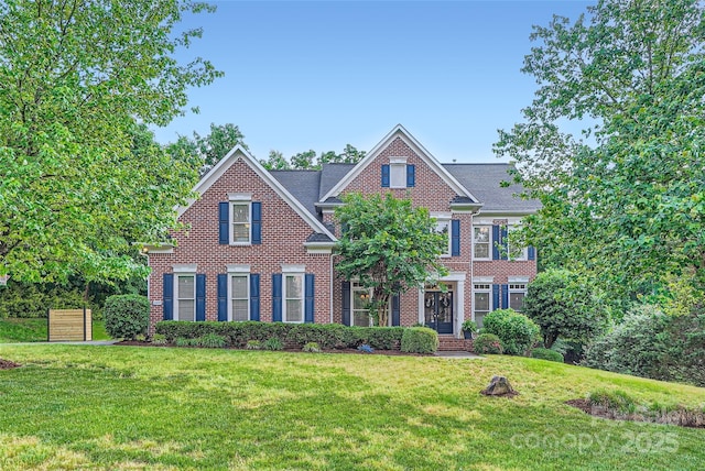 view of front of home with brick siding and a front yard