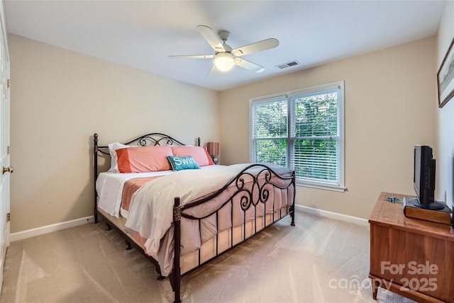 bedroom with light colored carpet, baseboards, ceiling fan, and visible vents