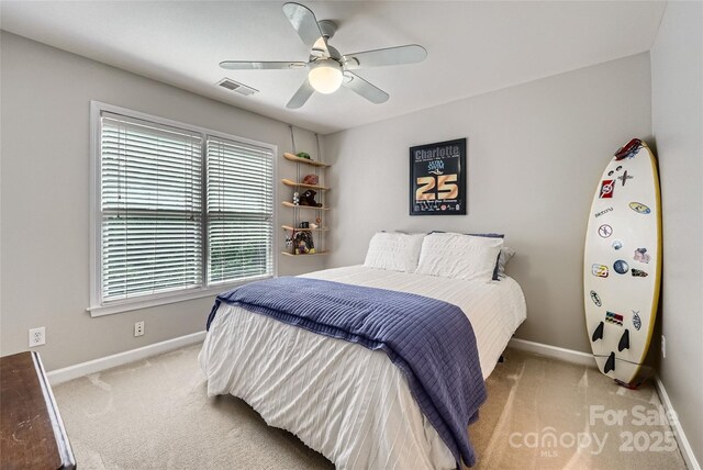 bedroom with ceiling fan, light carpet, baseboards, and visible vents