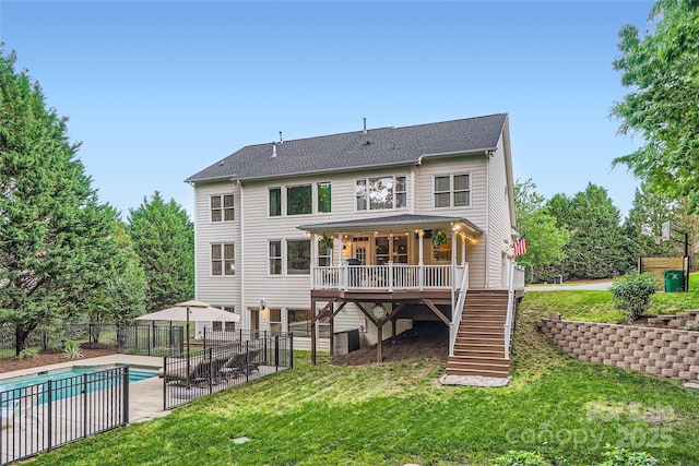 back of property featuring a lawn, a fenced in pool, fence, a patio, and stairs