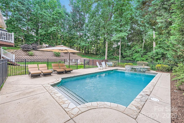 view of swimming pool featuring a patio area, a pool with connected hot tub, fence, and an outdoor living space