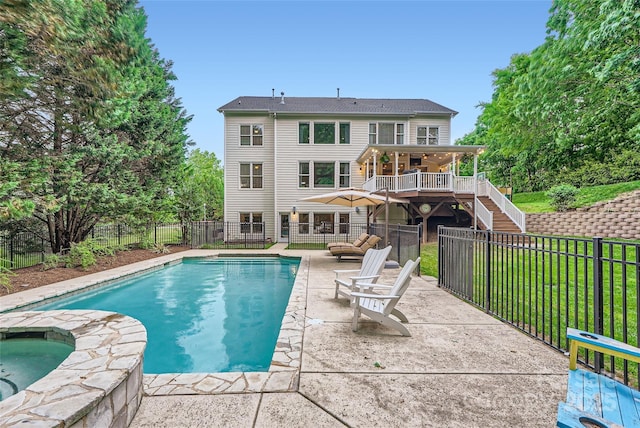 view of pool featuring stairway, a wooden deck, a fenced backyard, and a patio