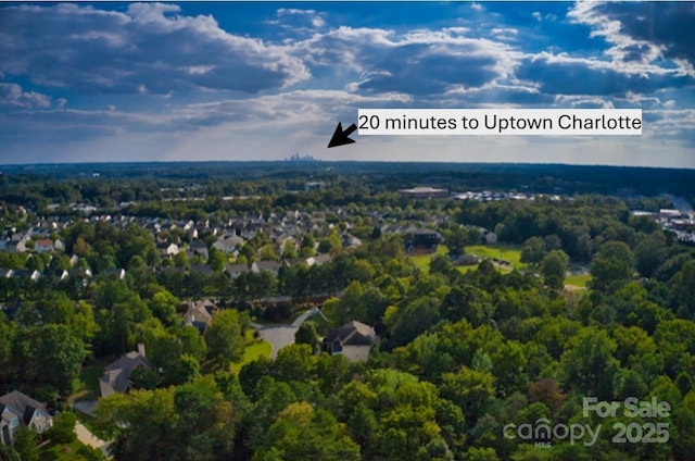 aerial view featuring a wooded view