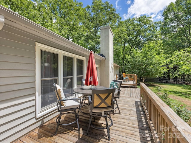 17501 Youngblood Rd, Charlotte, NC 28278 - deck with outdoor dining area, fence, and view of wooded area
