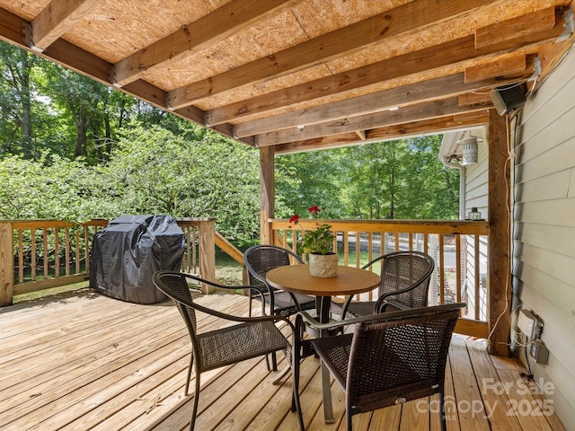 17501 Youngblood Rd, Charlotte, NC 28278 - wooden terrace featuring area for grilling, outdoor dining space, and view of scattered trees