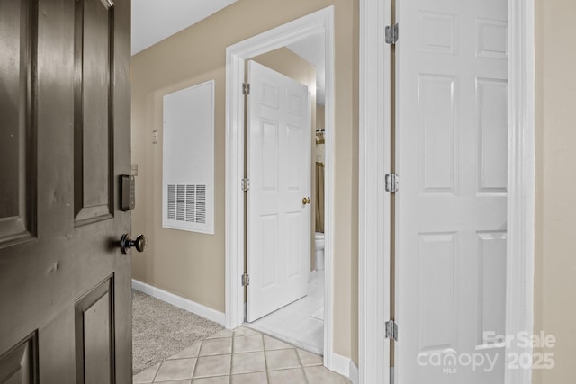 hall with light tile patterned floors and baseboards