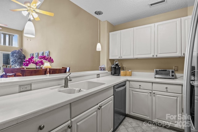 kitchen with a toaster, decorative light fixtures, dishwasher, visible vents, and a sink