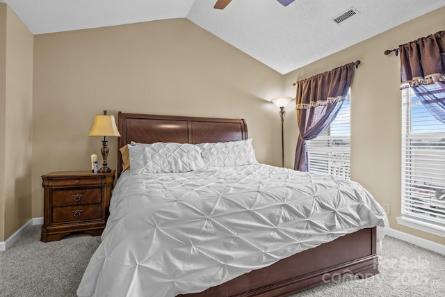 carpeted bedroom with baseboards, visible vents, a ceiling fan, and vaulted ceiling