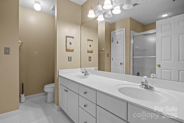 bathroom with toilet, baseboards, a sink, and a shower stall