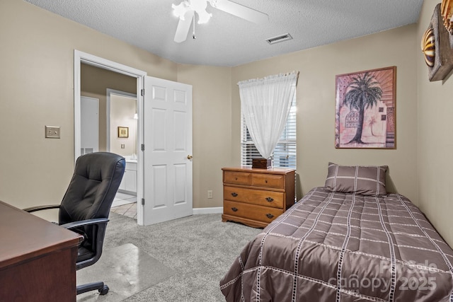 carpeted bedroom featuring a textured ceiling, visible vents, and ceiling fan