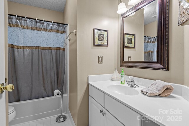 full bath with tile patterned floors, a textured ceiling, shower / tub combo, and vanity