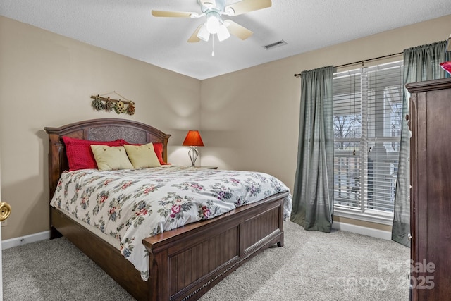 bedroom featuring light colored carpet, baseboards, ceiling fan, and visible vents