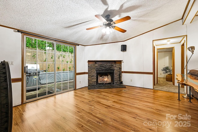 15 Robin Ln, Asheville, NC 28806 - living area with crown molding, wood finished floors, a textured ceiling, a ceiling fan, and a fireplace