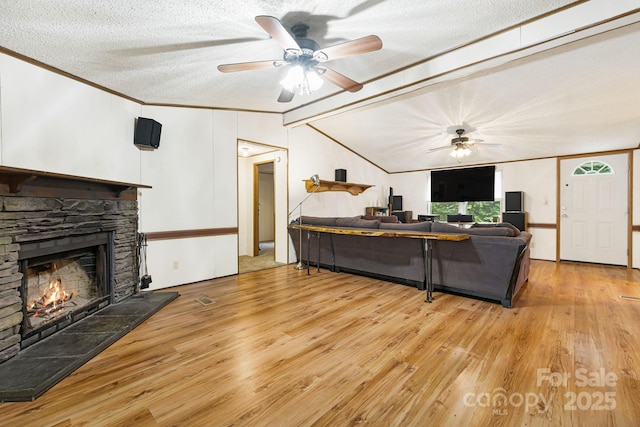 15 Robin Ln, Asheville, NC 28806 - living area with wood finished floors, a fireplace, a ceiling fan, a textured ceiling, and crown molding