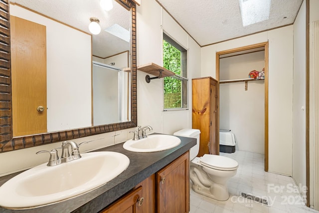 15 Robin Ln, Asheville, NC 28806 - full bathroom with a stall shower, double vanity, a textured ceiling, toilet, and a closet