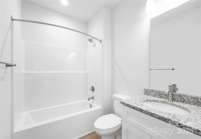 full bath with toilet,  shower combination, vanity, and wood finished floors