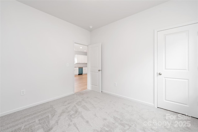 unfurnished bedroom featuring carpet and baseboards