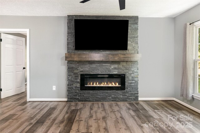 131 Scotland Dr, Mooresville, NC 28115 - unfurnished living room featuring baseboards, a fireplace, and wood finished floors