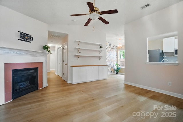1162 Willet Dr, Rock Hill, SC 29732 - unfurnished living room with a ceiling fan, light wood-style floors, baseboards, a tile fireplace, and high vaulted ceiling
