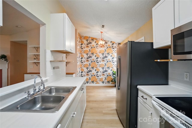 1162 Willet Dr, Rock Hill, SC 29732 - kitchen with wallpapered walls, stainless steel microwave, open shelves, white cabinets, and a textured ceiling