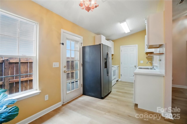 1162 Willet Dr, Rock Hill, SC 29732 - kitchen with stainless steel refrigerator with ice dispenser, light wood-type flooring, light countertops, and vaulted ceiling