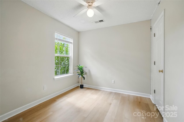 1162 Willet Dr, Rock Hill, SC 29732 - empty room with light wood-type flooring, baseboards, a ceiling fan, and a textured ceiling