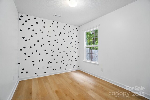 1162 Willet Dr, Rock Hill, SC 29732 - empty room with light wood finished floors, a textured ceiling, and baseboards