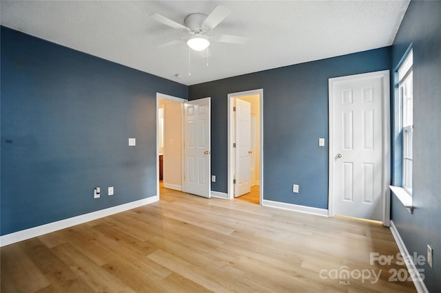 1162 Willet Dr, Rock Hill, SC 29732 - unfurnished bedroom featuring light wood-type flooring, baseboards, ensuite bath, and ceiling fan