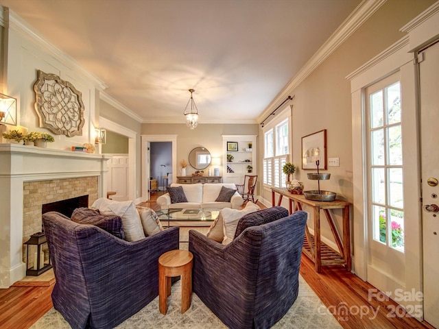 226 Union St S, Concord, NC 28025 - living area featuring wood finished floors, crown molding, and a brick fireplace