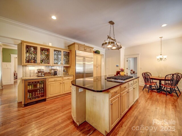 226 Union St S, Concord, NC 28025 - kitchen featuring wine cooler, stainless steel appliances, ornamental molding, light wood-type flooring, and glass insert cabinets