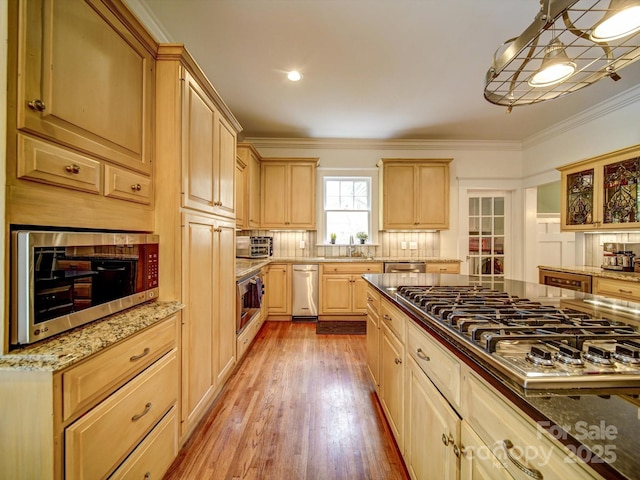 226 Union St S, Concord, NC 28025 - kitchen with appliances with stainless steel finishes, light brown cabinets, crown molding, a sink, and light wood-style flooring