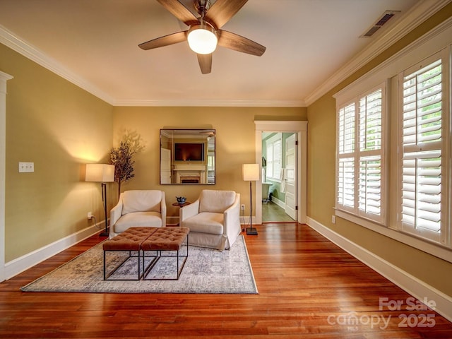 226 Union St S, Concord, NC 28025 - living area featuring healthy amount of natural light, wood finished floors, ceiling fan, baseboards, and ornamental molding