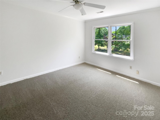carpeted empty room featuring baseboards, a ceiling fan, and visible vents