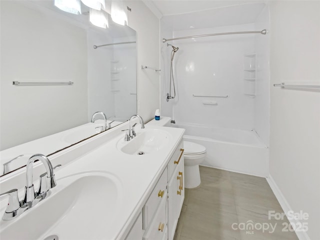 full bath featuring a sink, double vanity, toilet, and shower / bathing tub combination
