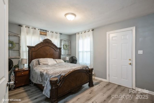 bedroom featuring wood finished floors and baseboards