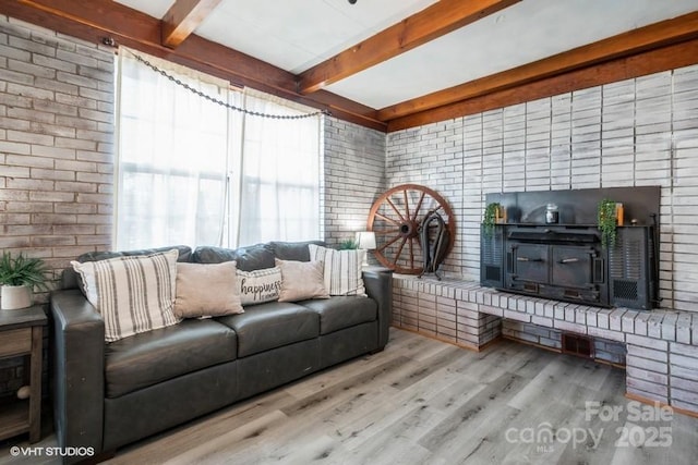 living room featuring wood finished floors and beamed ceiling