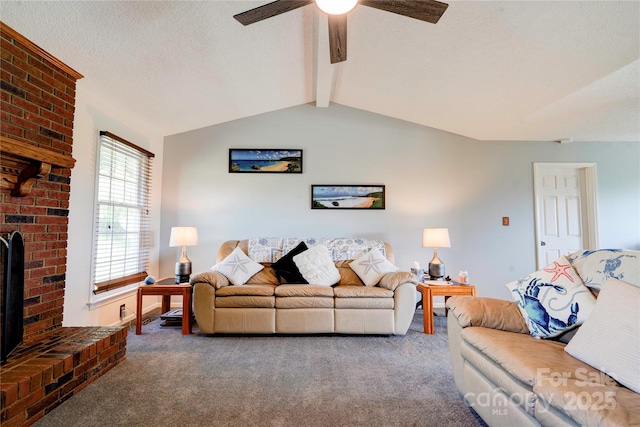 living area featuring carpet flooring, a fireplace, ceiling fan, and lofted ceiling with beams