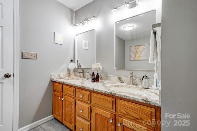 full bath with tile patterned flooring, double vanity, and a sink
