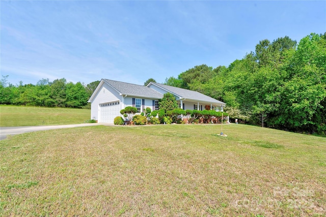 single story home featuring driveway, a front lawn, and an attached garage