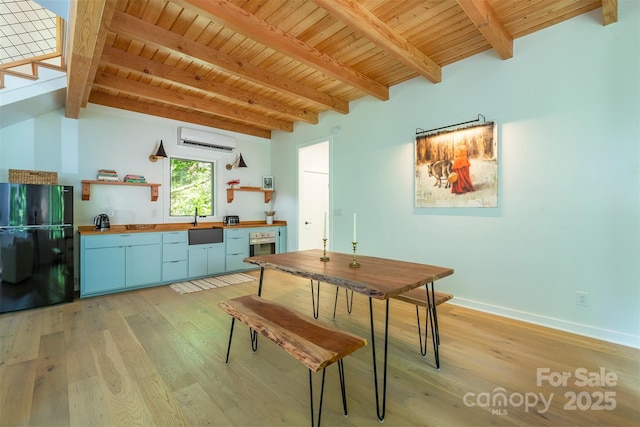 dining space featuring an AC wall unit, light wood-type flooring, beam ceiling, wooden ceiling, and baseboards