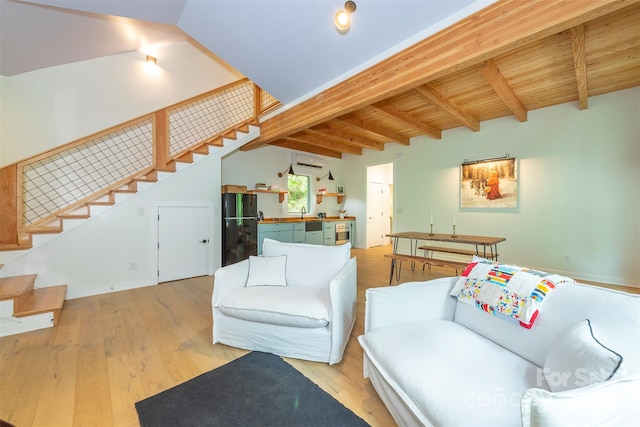 living area featuring stairway, an AC wall unit, light wood-type flooring, and wood ceiling
